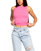 A fashionable women wearing pink crop top and denim jeans