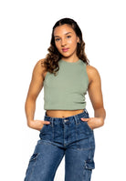 A fashionable women wearing green crop top and denim jeans